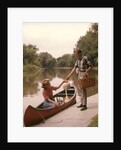 1960s Young Couple Loading Picnic Basket Thermos Into Canoe by Anonymous