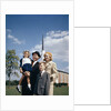 1960s Portrait Family Standing Together In Front Of Church Outdoor by Anonymous