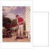 1960s Man Wearing Red Shirt Cooking Steak Outdoor On Backyard Grill by Anonymous