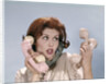 1960s Frustrated Young Redheaded Woman Trying To Answer Handle Five Telephone Receivers Studio by Anonymous