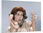 1960s Frustrated Young Redheaded Woman Trying To Answer Handle Five Telephone Receivers Studio by Anonymous