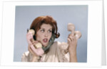 1960s Frustrated Young Redheaded Woman Trying To Answer Handle Five Telephone Receivers Studio by Anonymous