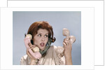 1960s Frustrated Young Redheaded Woman Trying To Answer Handle Five Telephone Receivers Studio by Anonymous