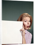 1960s Portrait Of Surprised Woman Peeking Around Sign Board by Anonymous