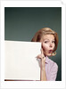 1960s Portrait Of Surprised Woman Peeking Around Sign Board by Anonymous