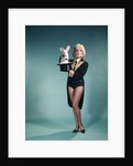1960s Young Woman In Stage Magician Coat And Short Shorts Pulling Rabbit Out Of Top Hat by Anonymous