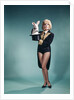 1960s Young Woman In Stage Magician Coat And Short Shorts Pulling Rabbit Out Of Top Hat by Anonymous