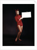 1960s Young Woman In Red Devil Costume Holding Sign Board In Hands by Anonymous