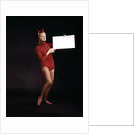 1960s Young Woman In Red Devil Costume Holding Sign Board In Hands by Anonymous