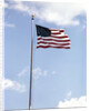 1960s American Flag On Pole Flying Against Blue Sky With Clouds by Anonymous
