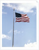 1960s American Flag On Pole Flying Against Blue Sky With Clouds by Anonymous