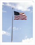 1960s American Flag On Pole Flying Against Blue Sky With Clouds by Anonymous