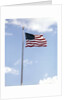 1960s American Flag On Pole Flying Against Blue Sky With Clouds by Anonymous