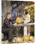1960s Young Couple Man Woman In Autumn Woods Carving Halloween Jack-O-Lantern Pumpkin by Anonymous
