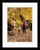 1960s Family Trio Father Mother Daughter Walking In Autumn Woods Carrying Pumpkins by Anonymous