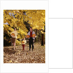 1960s Family Trio Father Mother Daughter Walking In Autumn Woods Carrying Pumpkins by Anonymous