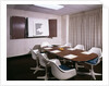 1960s Office Conference Room With Table Chairs Writing Pads Ashtray And Wall Chart by Anonymous