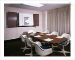 1960s Office Conference Room With Table Chairs Writing Pads Ashtray And Wall Chart by Anonymous