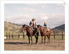 1970s Father And Son Sitting Together On Horses By Corral Wearing Hats by Anonymous