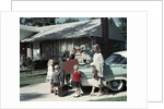 1950s 1960s Suburban Family Loading Ford Four Door Sedan Automobile For Trip by Anonymous