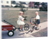 1950s Little Girl Sister Holding Doll Watching Little Boy Brother Repair Tricycle by Anonymous