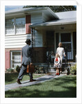 1950s Woman and Daughter Waiting At Front Steps For Man Coming Home by Anonymous