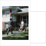 1950s Woman and Daughter Waiting At Front Steps For Man Coming Home by Anonymous