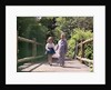 1960s Little Boy And Girl Holding Hands And Walking Across Wooden Footbridge by Anonymous