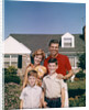 1960s Portrait Family Father Mother Two Sons Standing Together In Front Of Suburban House by Anonymous