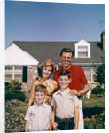 1960s Portrait Family Father Mother Two Sons Standing Together In Front Of Suburban House by Anonymous
