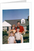 1960s Portrait Family Father Mother Two Sons Standing Together In Front Of Suburban House by Anonymous