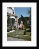 1940s 1950s Family Father Mother Daughter Son Leaving Suburban House Carrying Luggage by Anonymous