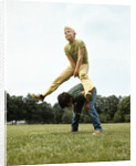 1970s Two Boys Jumping Playing Leapfrog by Corbis