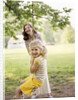 1970s Woman Mother With Girl Daughter Swinging Playing On Rope Swing by Anonymous
