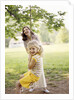 1970s Woman Mother With Girl Daughter Swinging Playing On Rope Swing by Anonymous