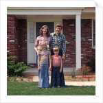 1970s Family Posing On Front Lawn Outside House by Anonymous