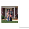 1970s Family Posing On Front Lawn Outside House by Anonymous