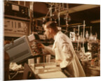 1960s Scientist Lab Technician Looking Into Oscilloscope In Laboratory by Anonymous