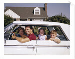 1960s Father And Mother With Son And Daughter Sitting In White Four Door Sedan Automobile by Anonymous