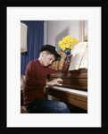 1960s 1970s Impatient Annoyed Looking Boy With Baseball Cap And Glove Practicing Piano Lesson by Anonymous