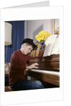 1960s 1970s Impatient Annoyed Looking Boy With Baseball Cap And Glove Practicing Piano Lesson by Anonymous