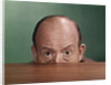 1960s Balding Man Peeking Over Desktop With Only Top Half Of Head Showing by Anonymous
