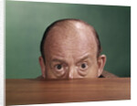 1960s Balding Man Peeking Over Desktop With Only Top Half Of Head Showing by Anonymous