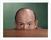 1960s Balding Man Peeking Over Desktop With Only Top Half Of Head Showing by Anonymous