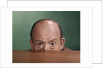 1960s Balding Man Peeking Over Desktop With Only Top Half Of Head Showing by Anonymous