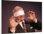 1960s Blindfolded Senior Man Businessman Arms Reaching Grasping Feeling Way by Anonymous