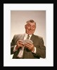 1960s Satisfied Man Looking At Hand Of Playing Cards by Anonymous
