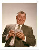 1960s Satisfied Man Looking At Hand Of Playing Cards by Anonymous