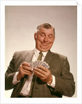 1960s Satisfied Man Looking At Hand Of Playing Cards by Anonymous