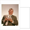 1960s Satisfied Man Looking At Hand Of Playing Cards by Anonymous
